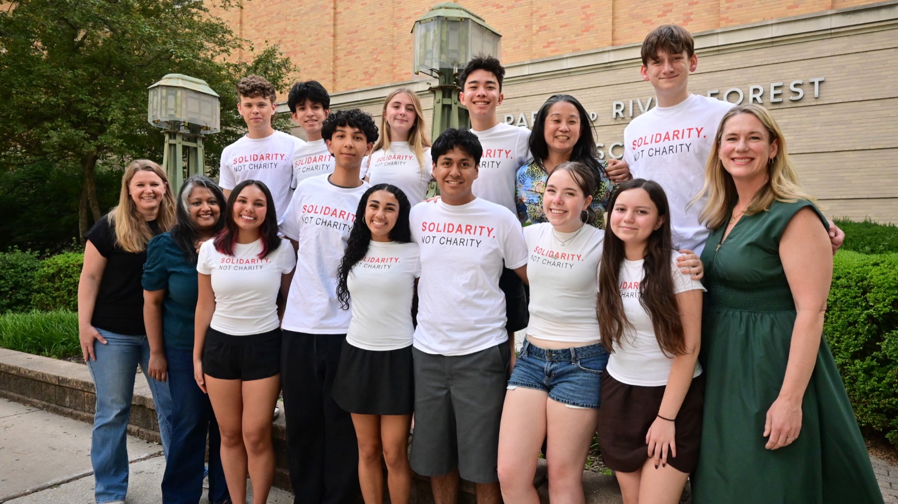The Students Feeding Students crew in their Solidarity. Not Charity. shirts outside Oak Park River Forest High School